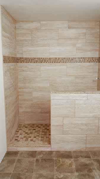 Large shower with mosaic tiles and backsplash
